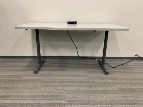 grey and black desk with power mount